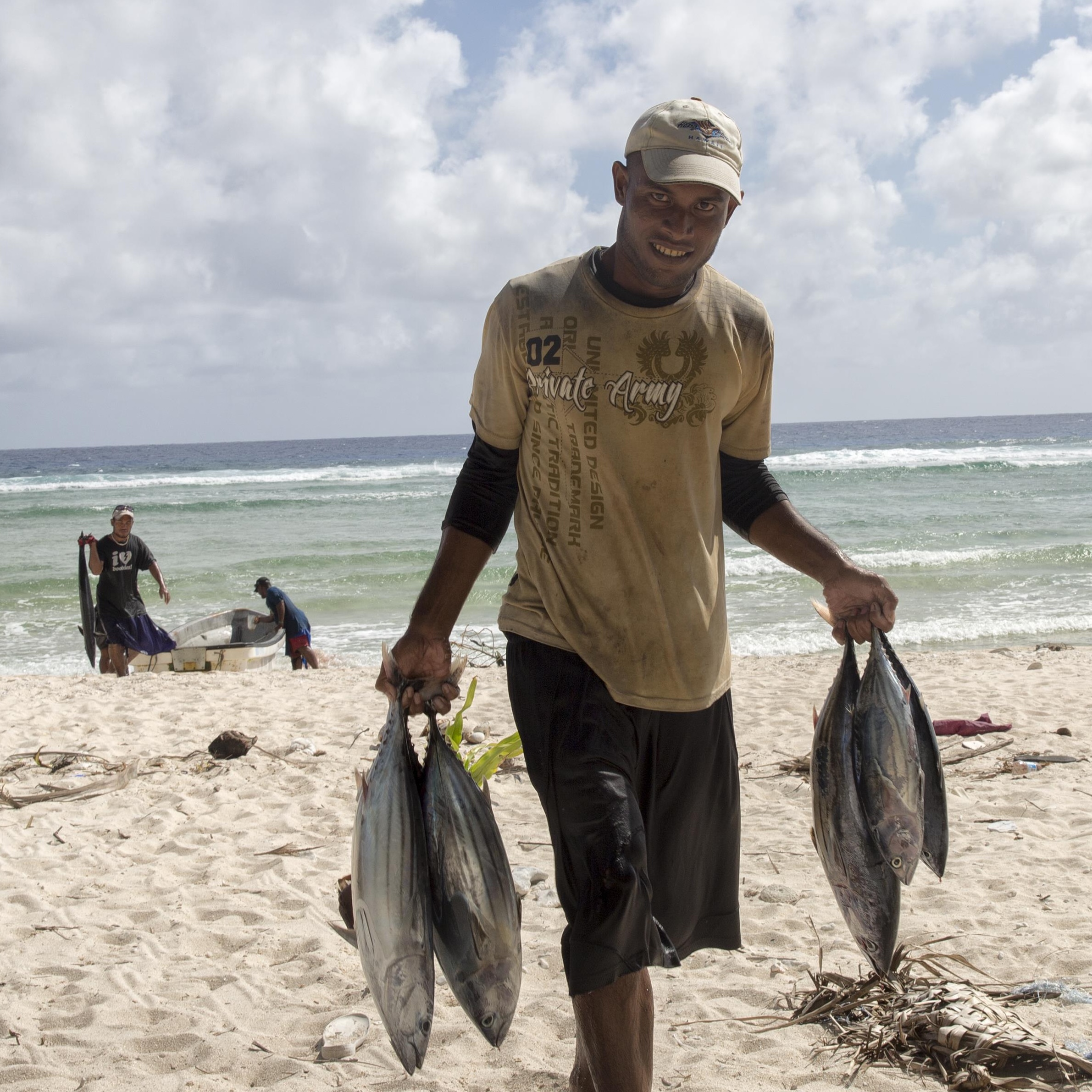 Man bringing in tuna from sea